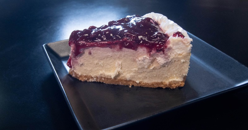 Cheesecake topped with berry sauce