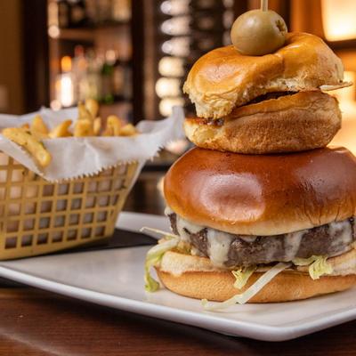 Cheeseburger, served with fries, front view, closeup.