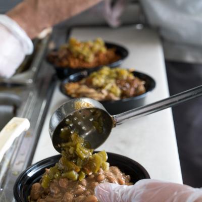 Pouring chili into a bowl.