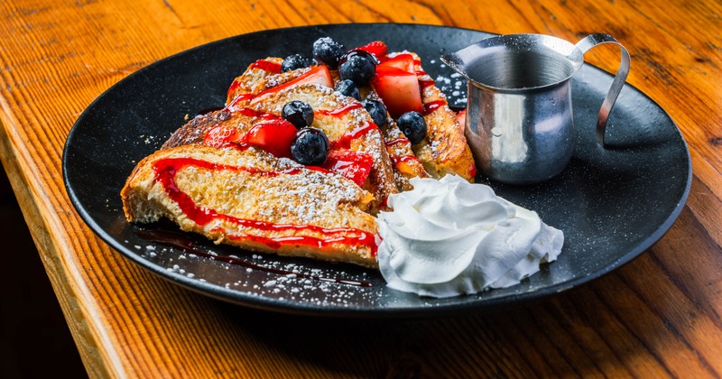 Berry stuffed French toast with whipped cream and syrup