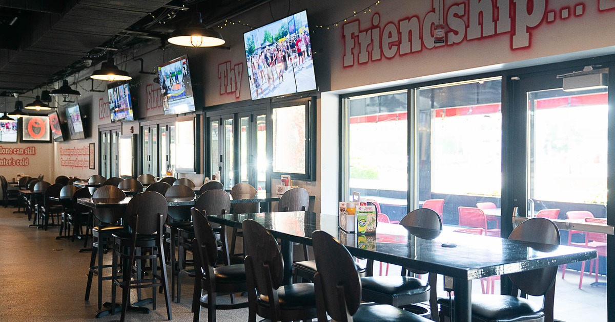 Interior, high seating area, high tables with stools, large glass doors with windows