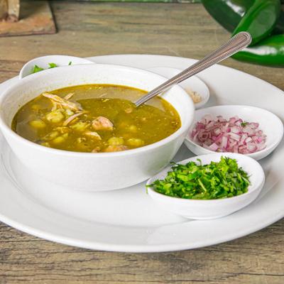 Chicken Pozole served with condiments on the side.