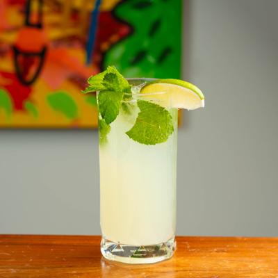 Mojito cocktail garnished with mint and a lime wedge.