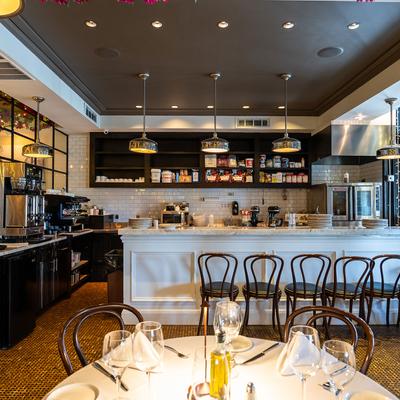 Fully set dining table, bar in the background.