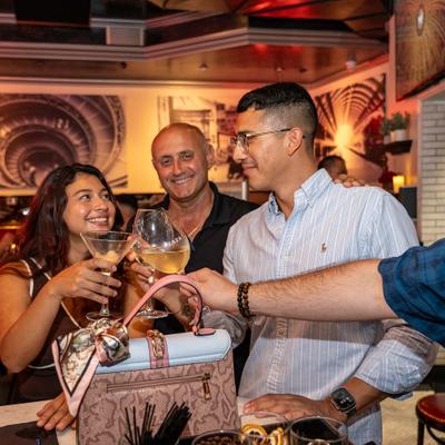 Guests clinking glasses in a group toast.