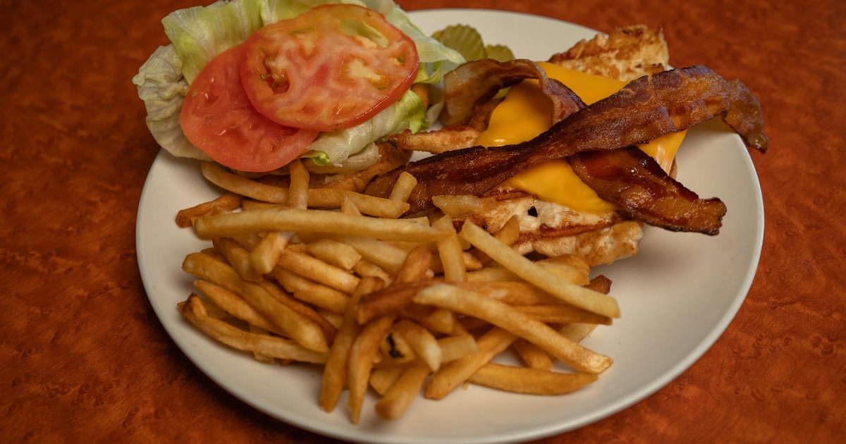A bacon cheeseburger with fries