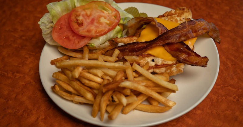 A bacon cheeseburger with fries