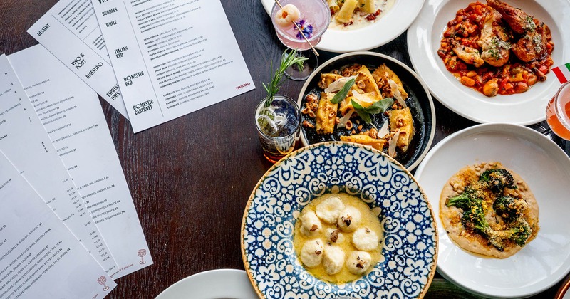 Assorted food plates and menus spread on a table