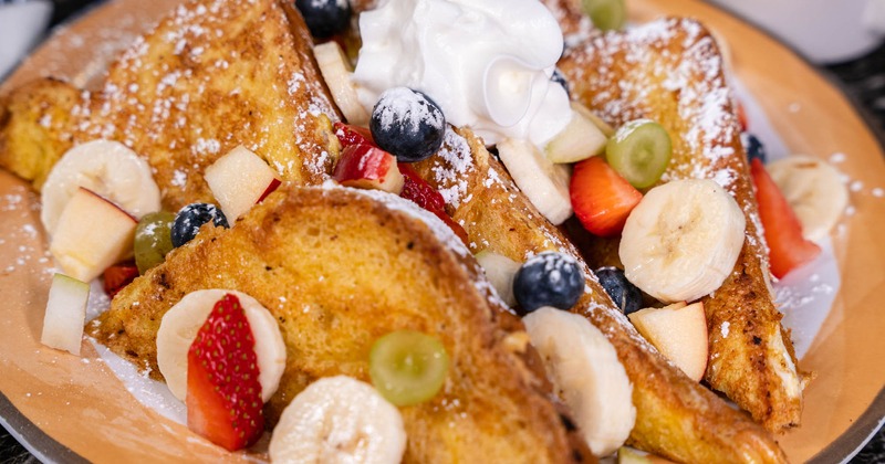 Fresh fruit and whipped cream on french toast, close up