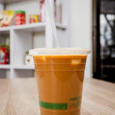 Iced latte in a clear plastic cup with a straw.