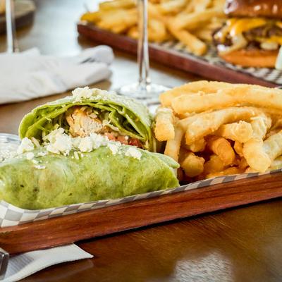 Mediterranean grilled chicken wrap served with french fries.