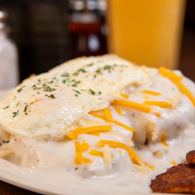 Biscuits and gravy, with fried eggs and cheese.