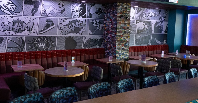 Interior, comic strip wall art and red booth seating