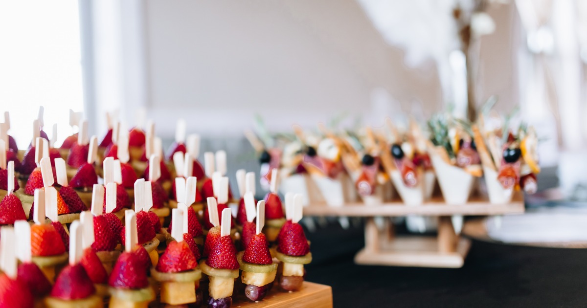 Fruit skewers displayed on a catering table
