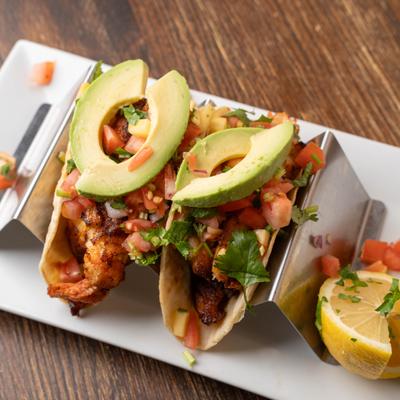 Grilled fish tacos with avocado and salsa.