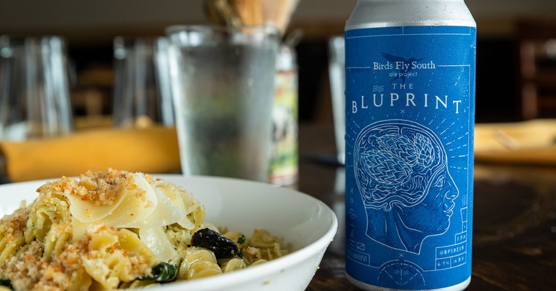 Rotelle pasta with bolognese sauce, shaved Parmesan and herbs, can of Blueprint