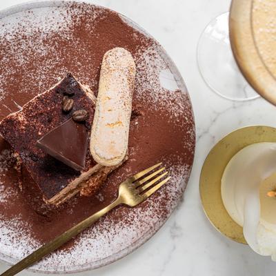 Tiramisu plate accompanied with espresso martini, top view.