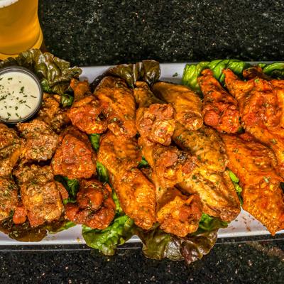 Buffalo wings and a glass of beer, top view.