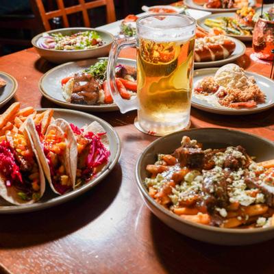 Various dishes served on the table with a jug of beer.