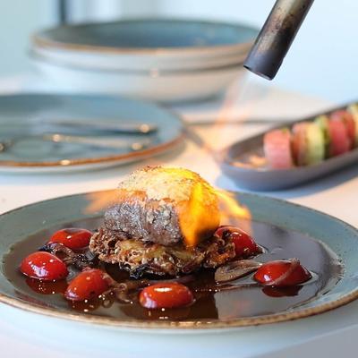 Wasabi crusted filet being flamed with a kicthen torch.