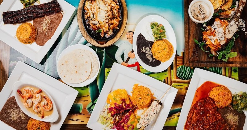 Various Mexican dishes arranged on a colorful table