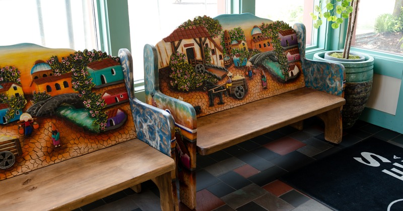 Decorated benches by window