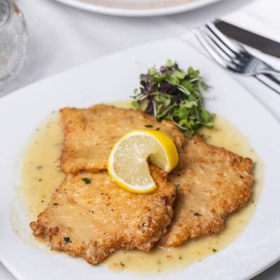 Parmesan-crusted chicken in a lemon white wine sauce.