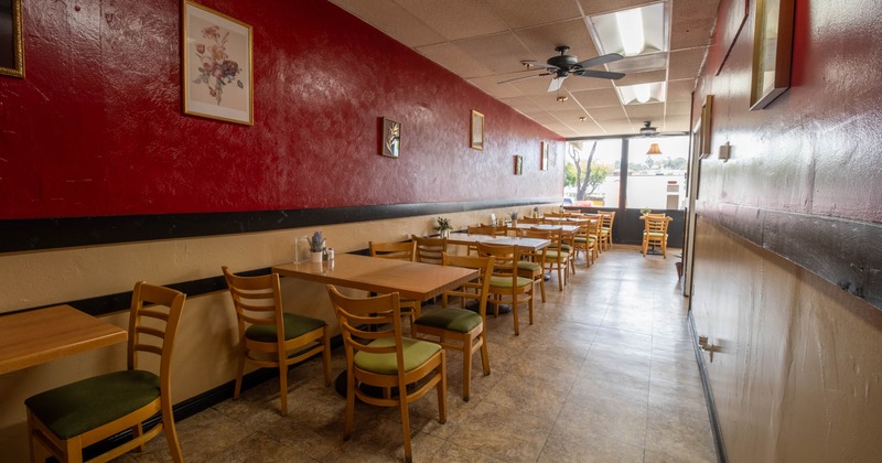 Interior, dining area, wooden tables and chairs for two and four people, ready for guests