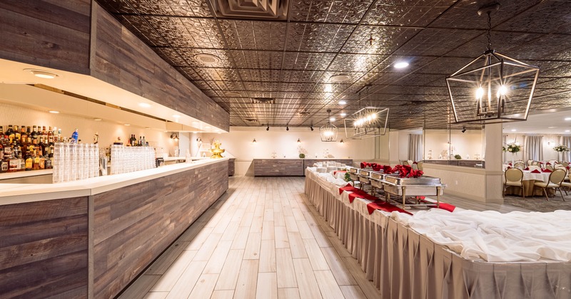 Restaurant interior with brick walls, wood floors, and tables