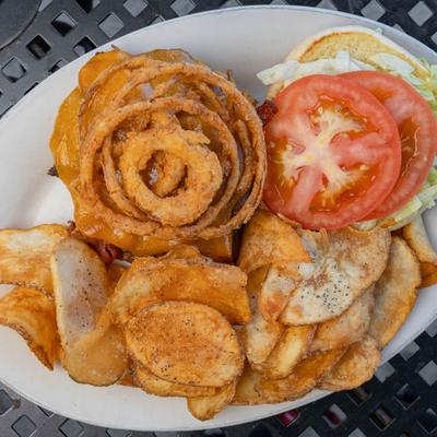 Southwest Burger topped with fried onions and served with chips.