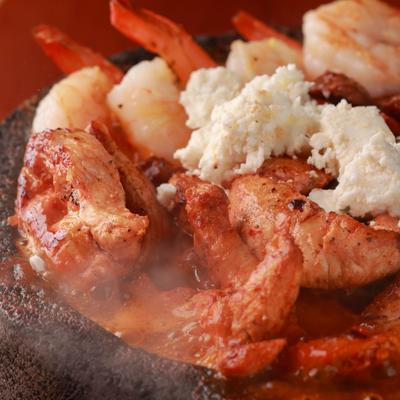 A close up of simmering hot molcajete