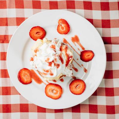 Butter Cake with vanilla ice cream and whipped cream, and fresh strawberries.