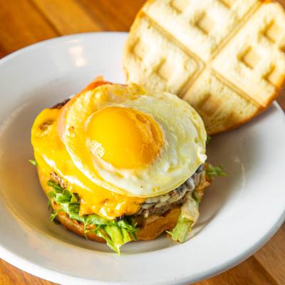 Twisted Burger with a sunny side up egg on top.
