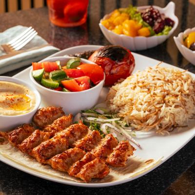 Chicken kebab, with rice, salad, and hummus.