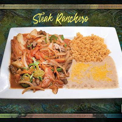 Steak Ranchero served with rice abd beans on the side.