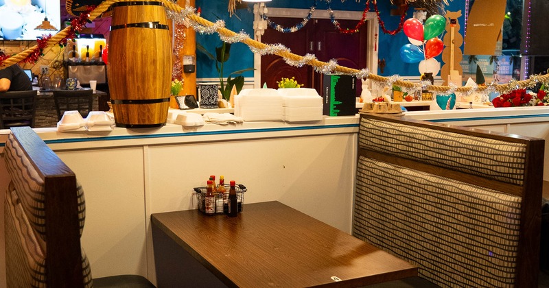 Interior of a vibrant restaurant featuring a cozy booth with a wooden table