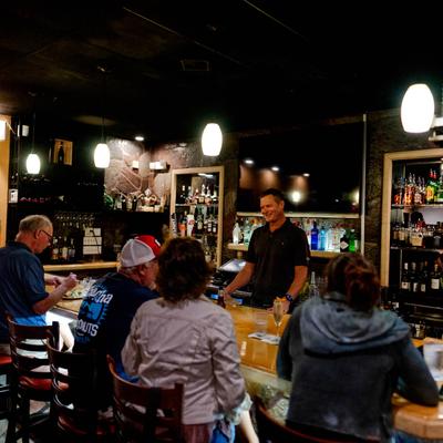 Customers sitting at the bar.