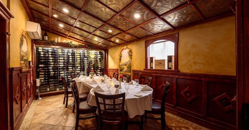 Interior, dining area with wine rack behind