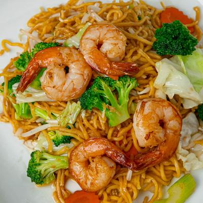 Shrimp atop egg noodle and vegetable stir fry.