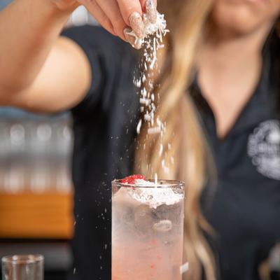 A staff member making a cocktail
