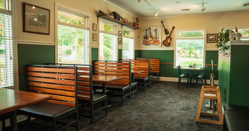 Interior of a restaurant featuring wooden booths and tables