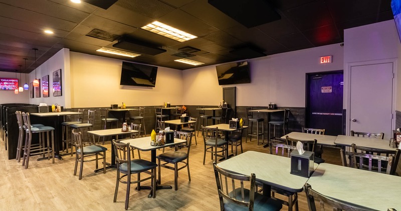 Interior, dining tables and seats, TVs on walls