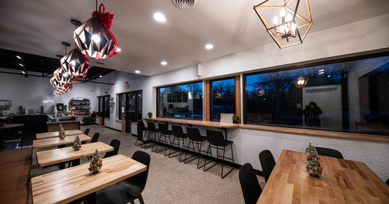Interior, seating area, regular wooden top tables and chairs, high seating