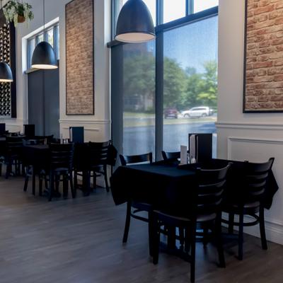 Outdoor dining tables with black tablecloth.