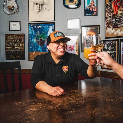 Two people toast with drinks.