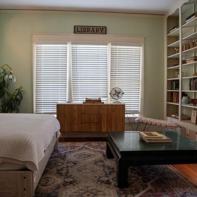 Bedroom with a coffee table and a bookshelf.