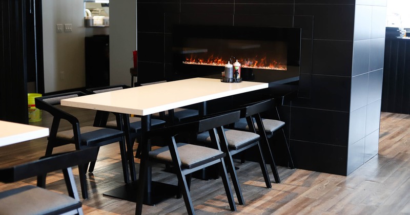 Interior, dining area, table for six, gas fire place in the tile covered wall