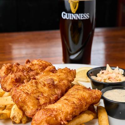 Braveheart's Fish & Chips with coleslaw, tartar sauce, and a glass of Guinness.