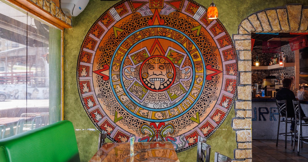 Dining room for six and a decorative mosaic on the wall