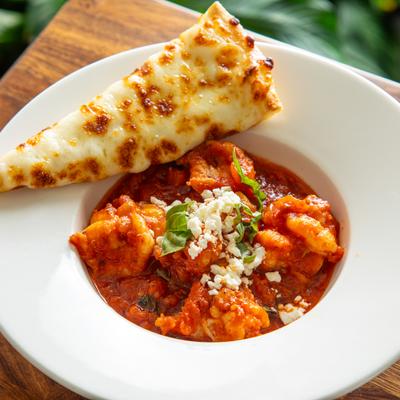 Mediterranean Shrimp with marinara sauce, feta and cheesy pita on the side.